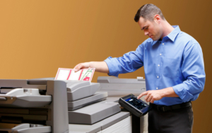 Man In Blue Shirt Printing On Hp Printer