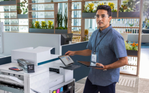 Man Repairing Hp Printer In Modern Office