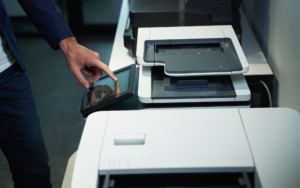 Person In Office Using Printer And Pressing On Its Screen