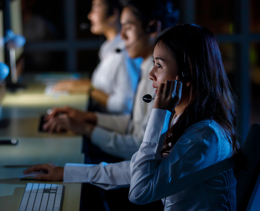 Side view, helpline operator wearing headphone with microphone while sitting Side View, Helpline Operator Wearing Headphone With Microphone While Sitting