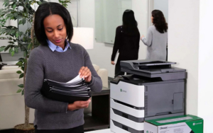 Woman With Folders Standing With Lexmark Printer