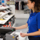 Woman using a Zebra label printer in a retail store